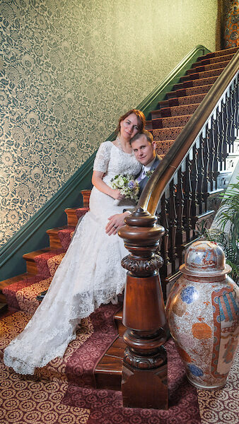 Bridal couple posing on a staircase